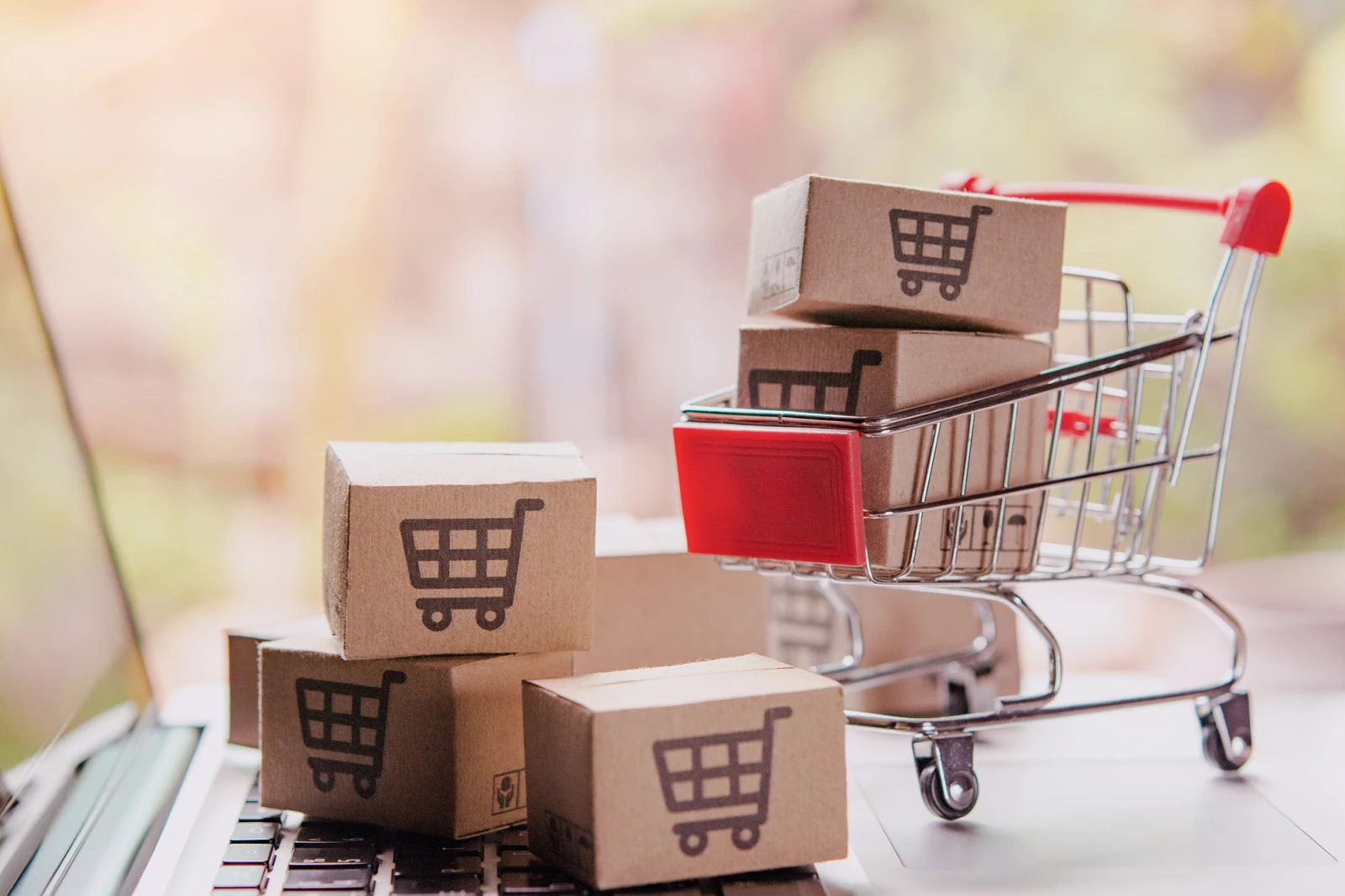 shopping-online-concept-parcel-or-paper-cartons-with-shopping-cart-logo-in-trolley-on-laptop-keyboard-shopping-service-on-the-online-web-offers-home-delivery